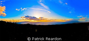 Sunset panorama taken from the side of Haleakala, Maui. by Patrick Reardon 
